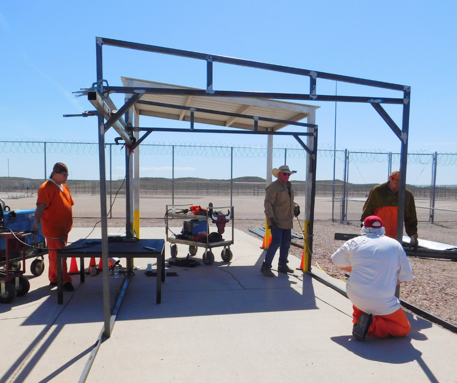 Three inmates complete the shade structure. 