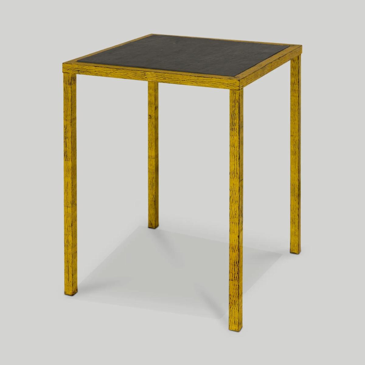 A square end table with a black top and a gold border and legs.