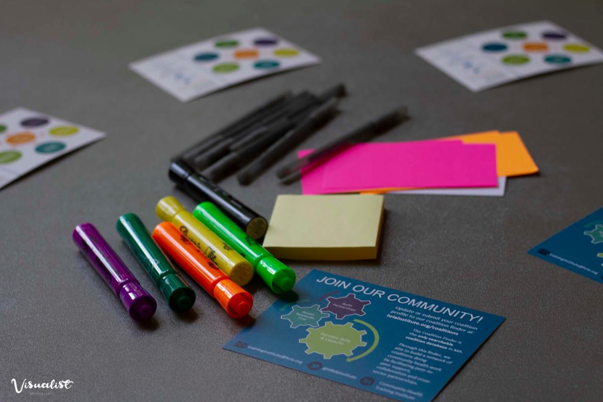Photo of colored markers, index cards, and promotional materials for the Community Health Training Institute.  This photo was taken at a training in 2019.