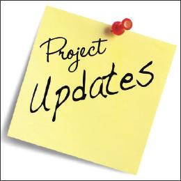 Post it note that says Project Updates tacked to a white background