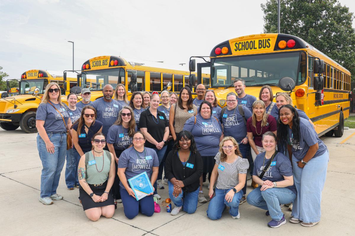 The 2026-27 cohort for FHSD's Citizens in our Schools program pose for a group picture in front of a row of school buses