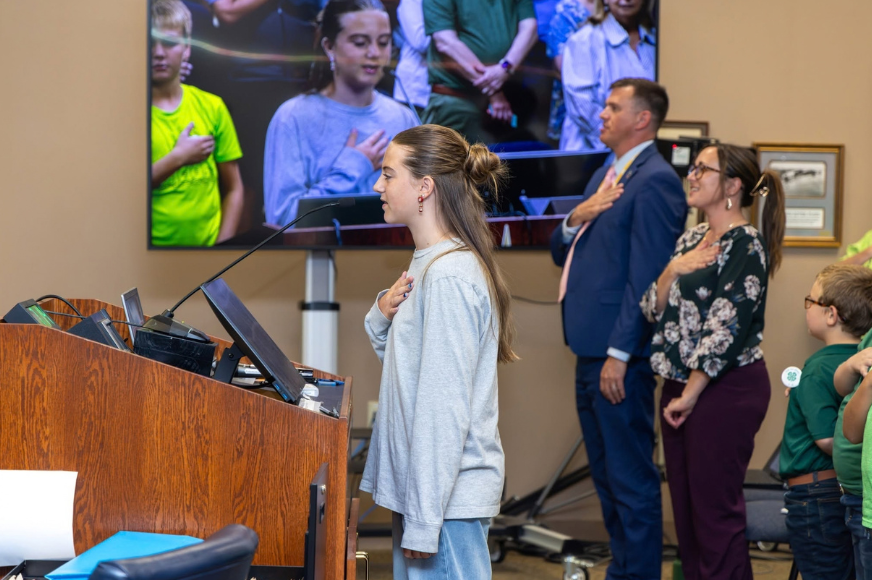 Lexi Costello leads the Pledge of Allegiance during a St. Charles City Government meeting
