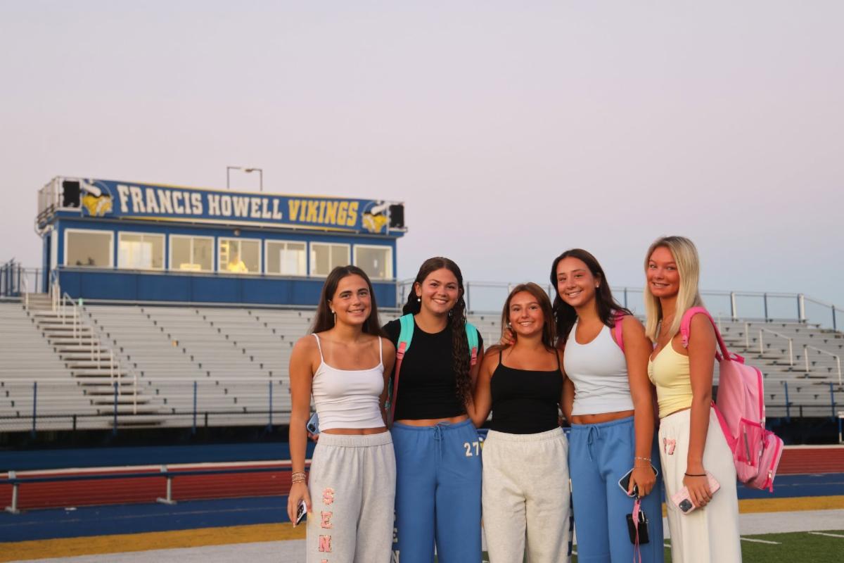 Francis Howell High School students pose for a photo in front of the press box at the football field during Senior Sunrise