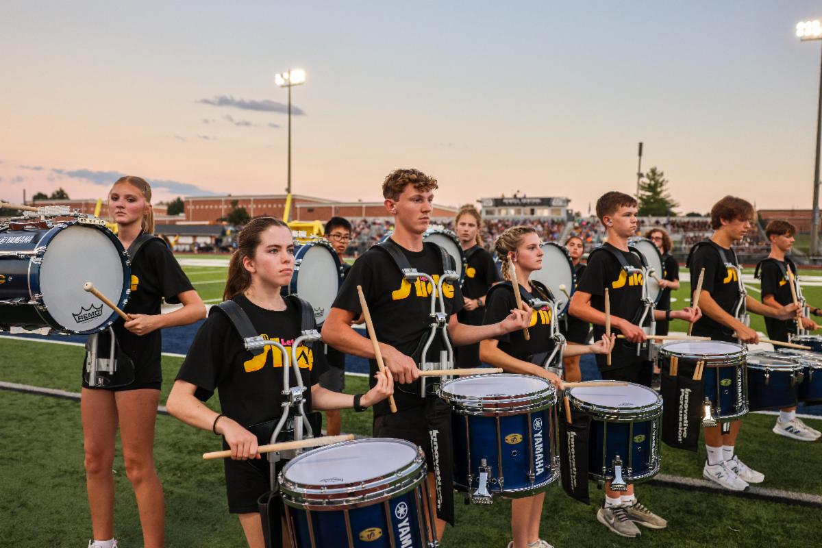 A group of marching drummers perform on the Francis Howell Central football field