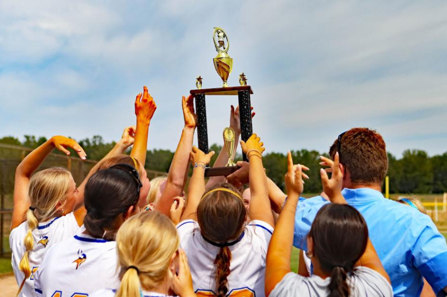 the FHHS softball team hoists the Summit Tournament championship trophy