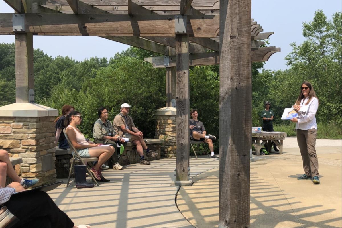 Jenn reading at LinkUp in July outside of the Watershed Stewardship Center