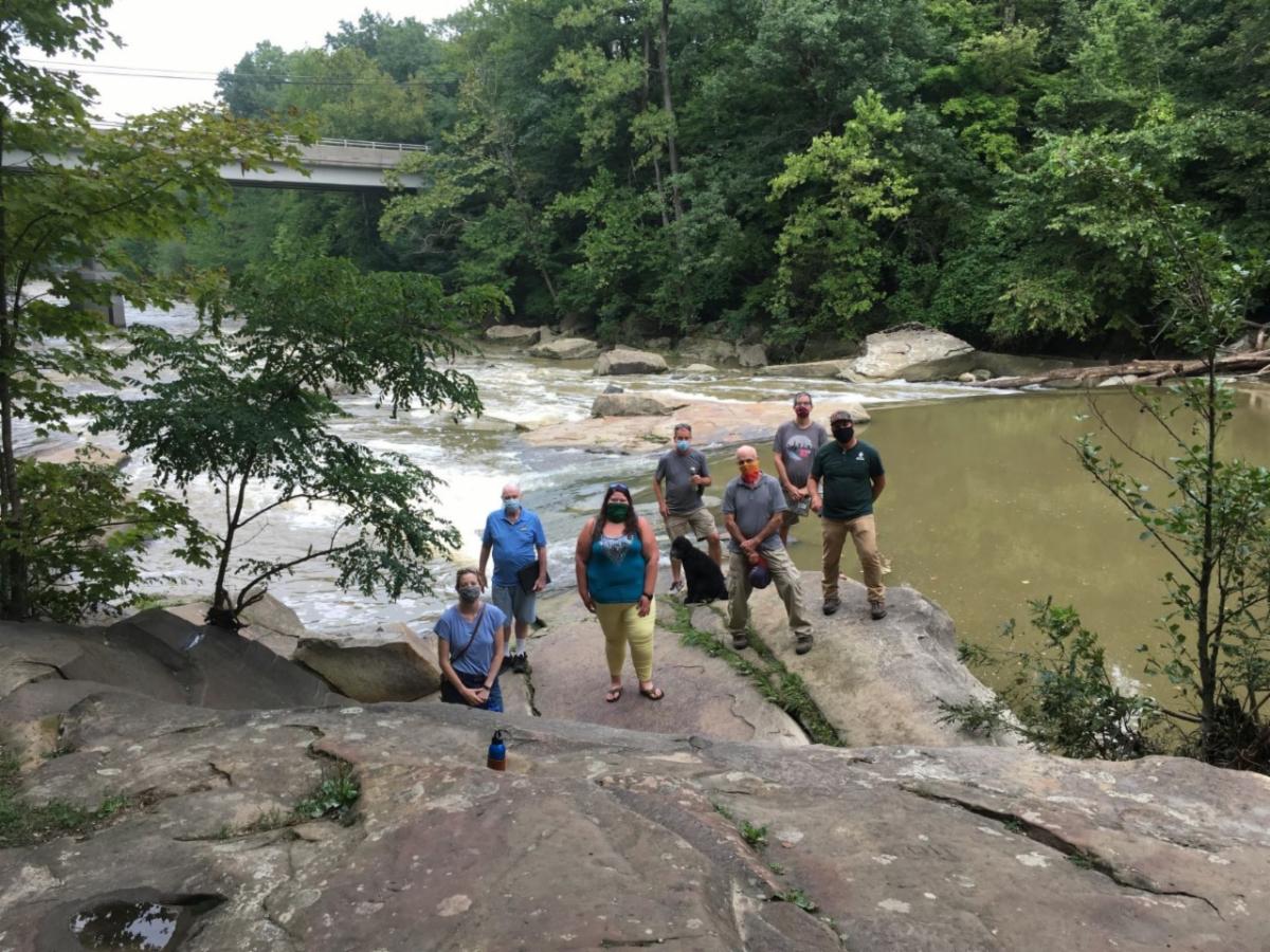 Rocky River board members standing on rocks along side Rocky River