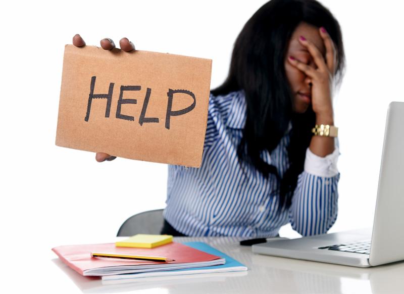 black African American ethnicity tired and frustrated woman working as secretary in stress at work office desk with computer laptop asking for help in business frustration concept