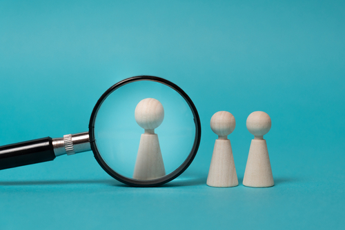 Concept of investigation_ research_ focus on a subject. Wooden figures on blue background