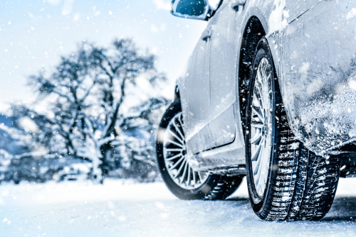Tire in winter on snow road. Tires on snow. Car detail.