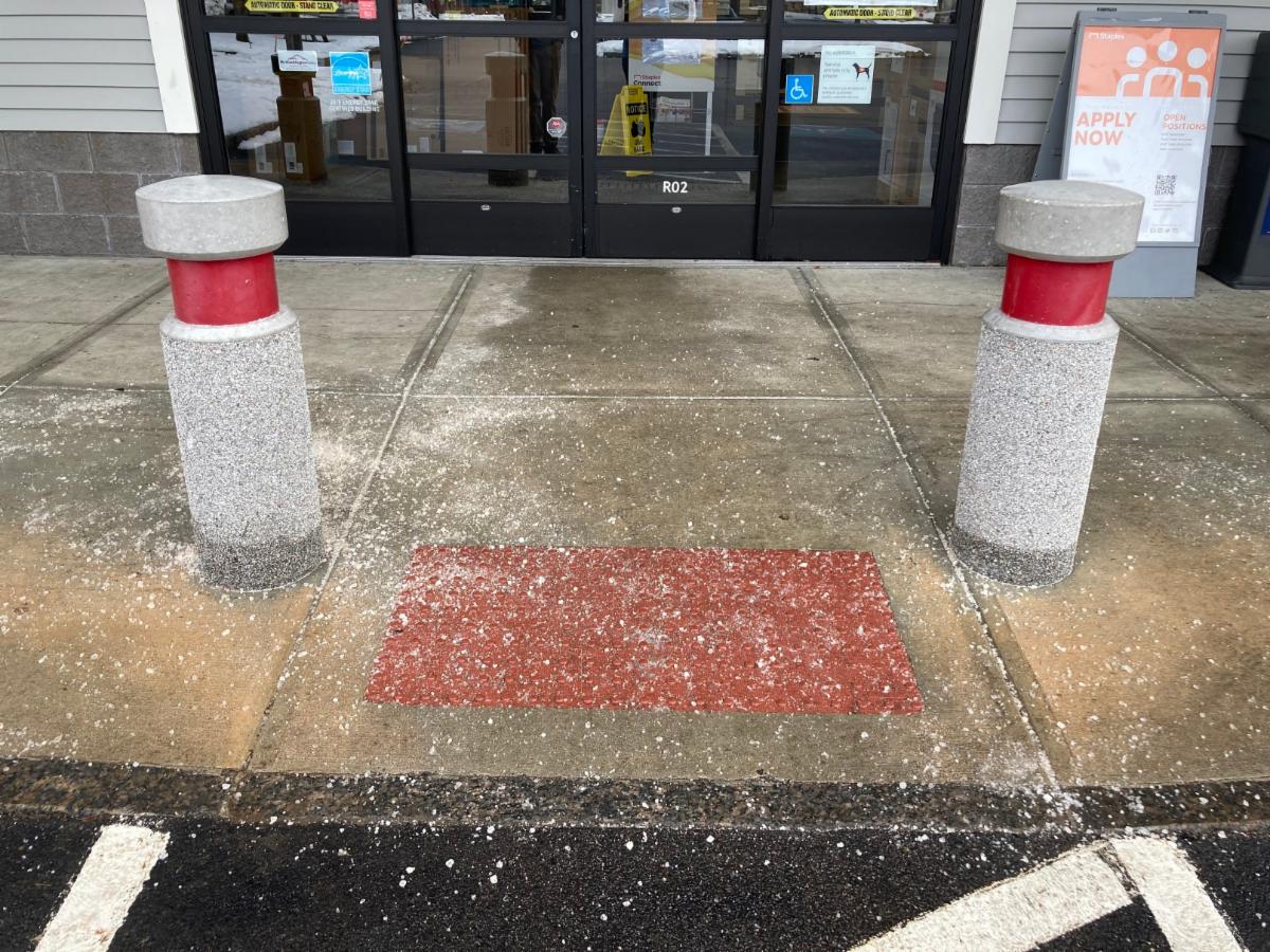 Store entryway with excess winter salt applied to sidewalk.