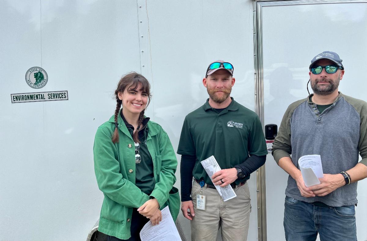 three people pose for a phot