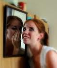 woman talking to mirror