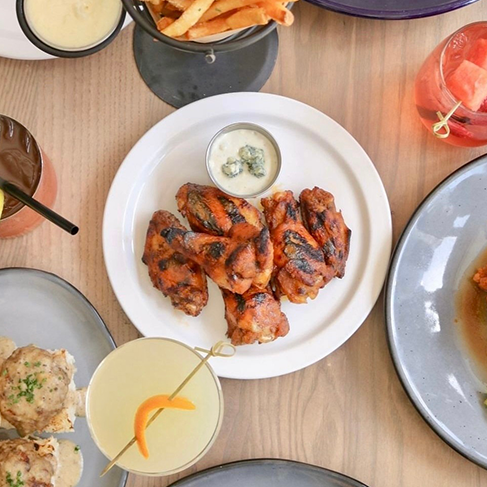 restaurant table with various plates of food and cups