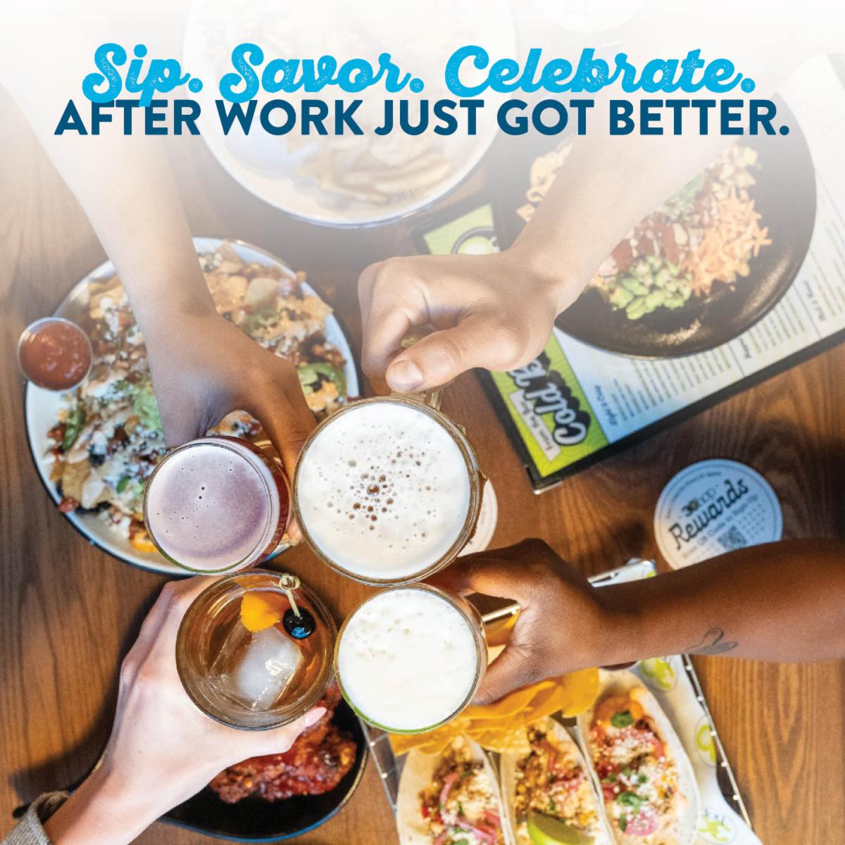 Food on table and group of people cheers drinks