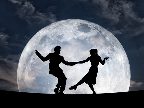 Silhouette of a dancing duo performing the swing dance move against a full moon night sky for the concept of party the night away. 3D illustration. Elements of this image furnished by NASA.