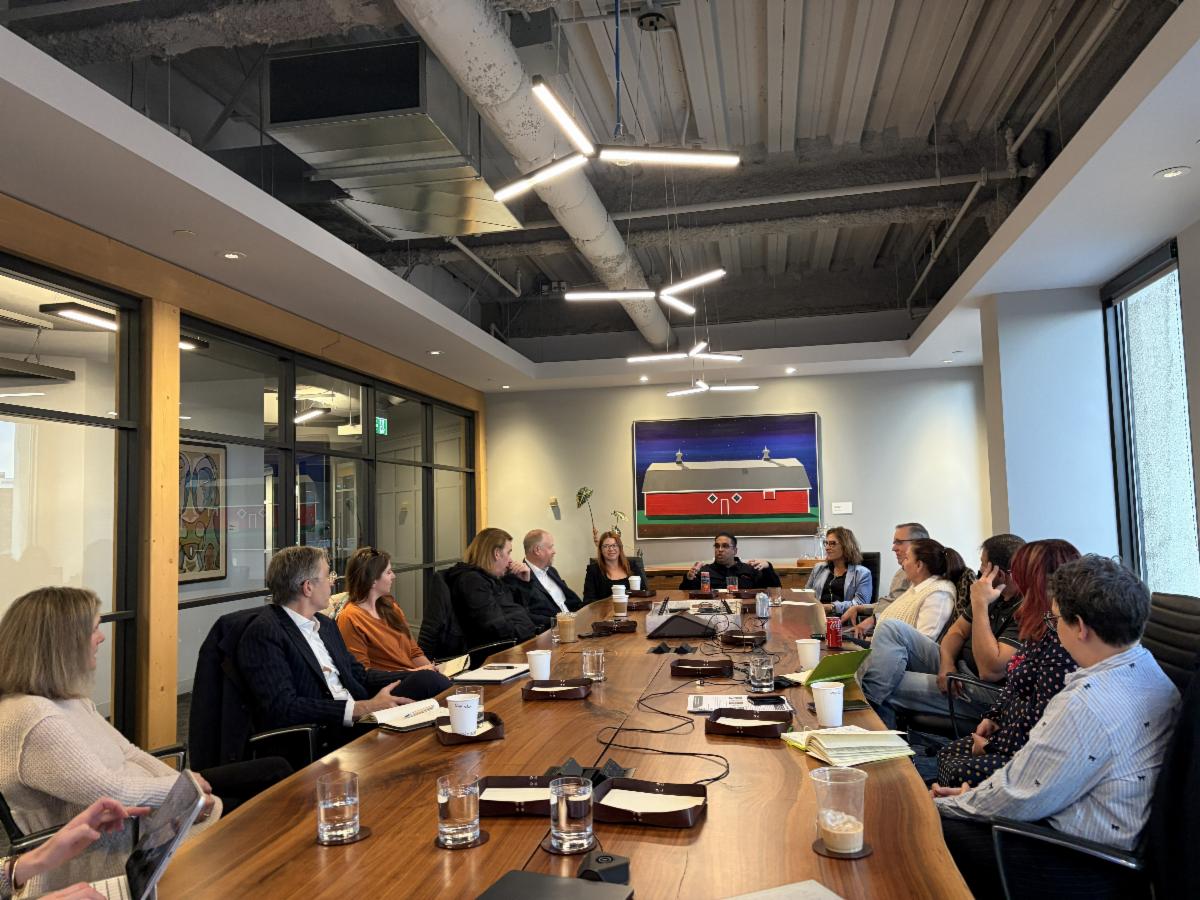 People sitting at a boardroom table in a meeting