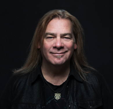 Alan Doyle black shirt on black background headshot