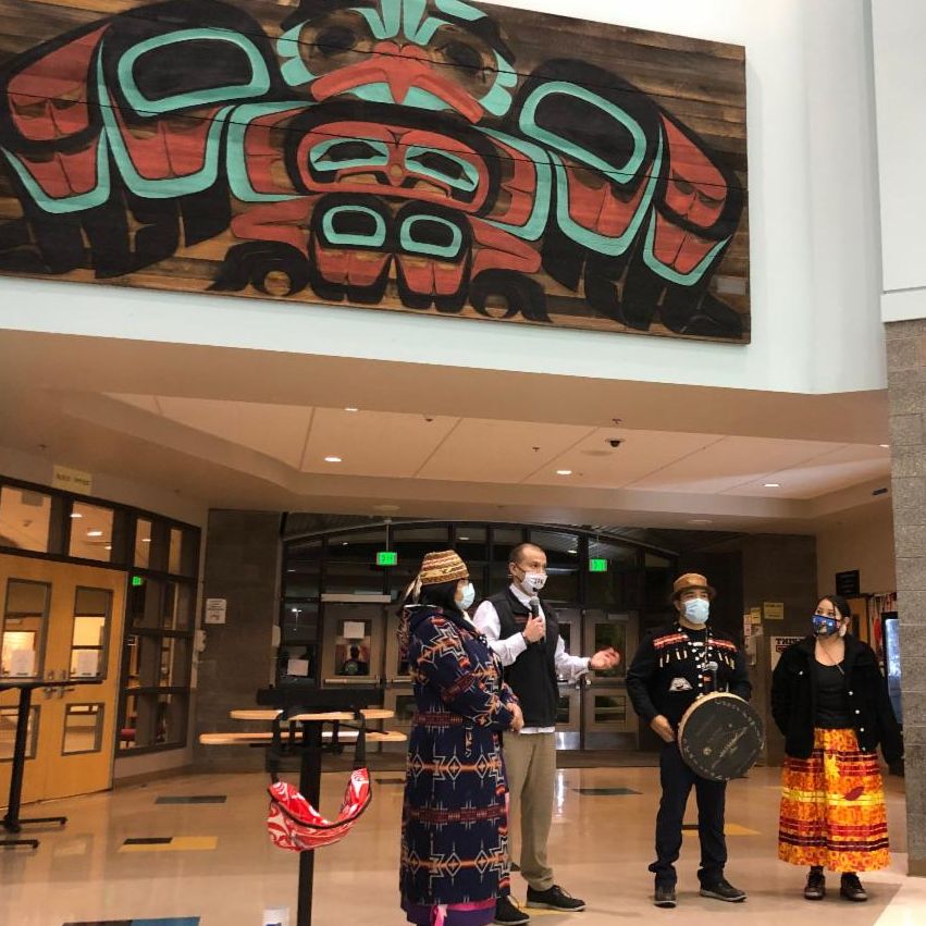 Nisqually Tribal Council Chairman Willie Frank III (second from left) welcomes attendees to the re-dedication of Marvin Oliver’s artwork Big Bird (1979), pictured above. The artwork was restored and installed in a new location in 2021.