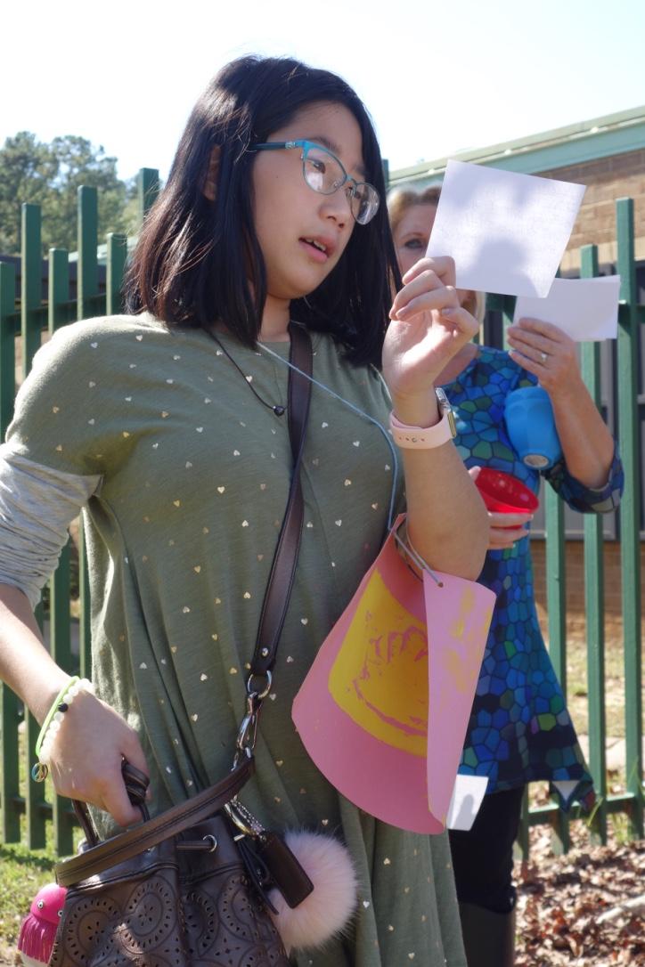 Young girl reading from a note card