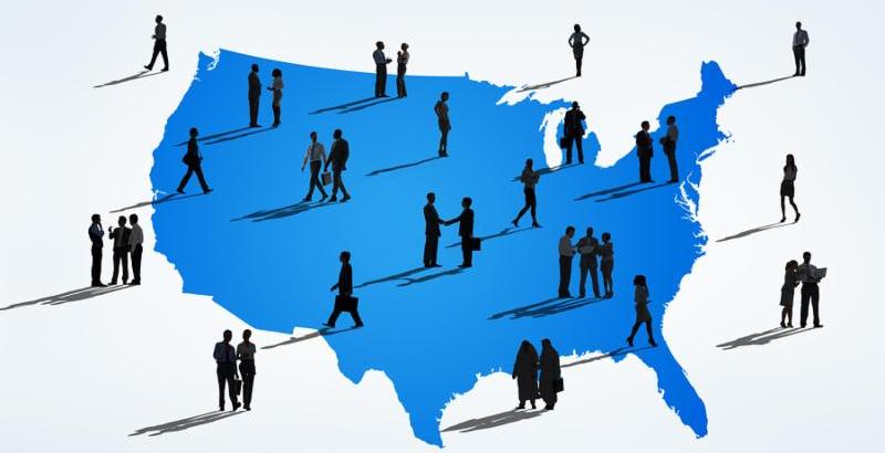 Silhouettes Of Multi-Ethnic Business People On A Blue Cartography Of USA
