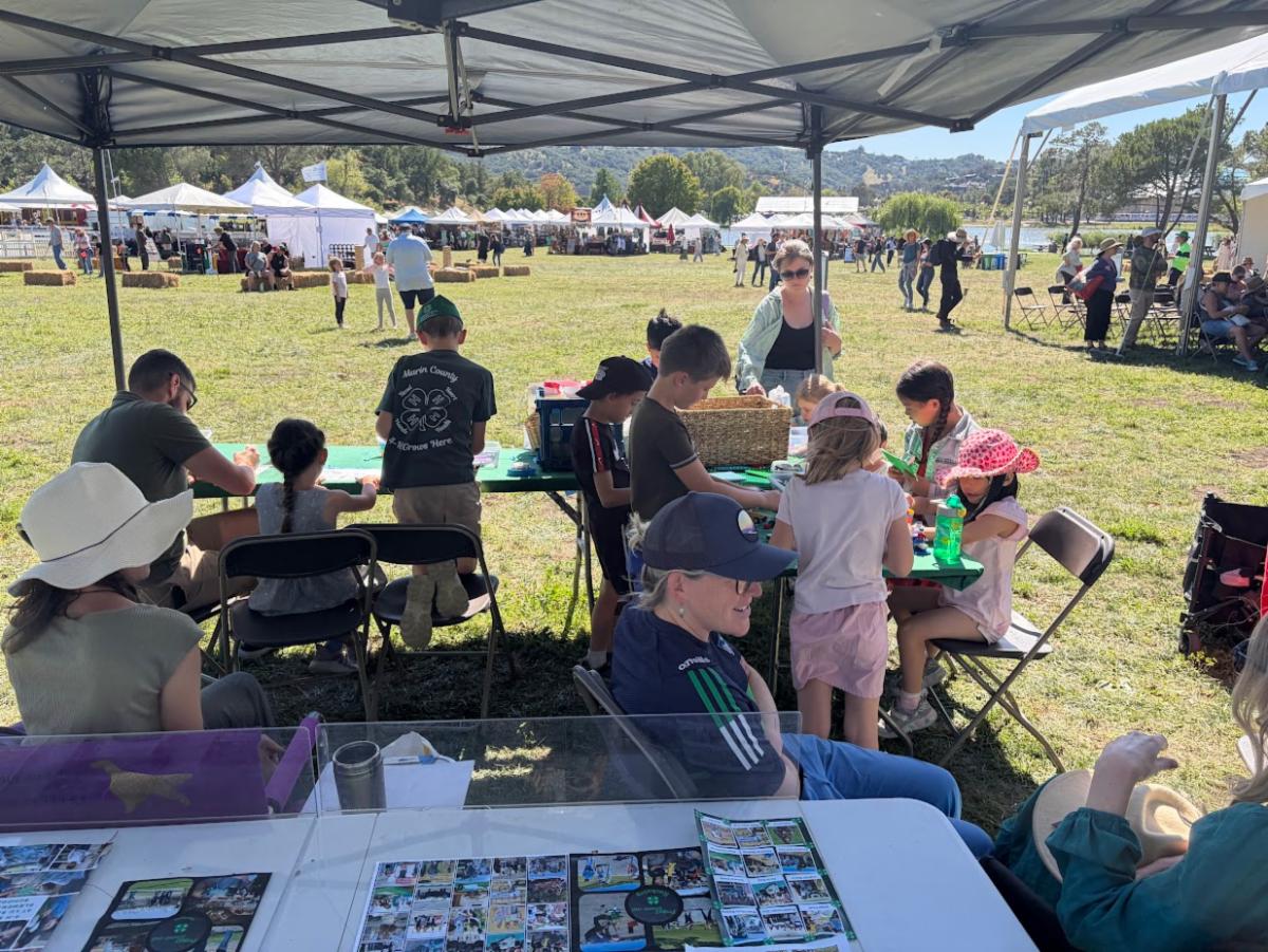 group of kids and parents at a 4-H booth