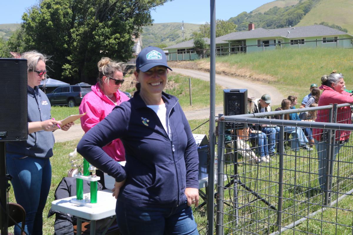 A woman in a navy blue vest smiling at the camera