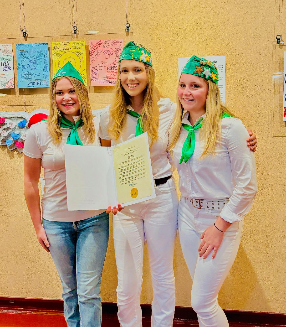 Marin 4-H County Ambassadors holding a proclamation of National 4-H week after the Marin County Board of Supervisors Meeting