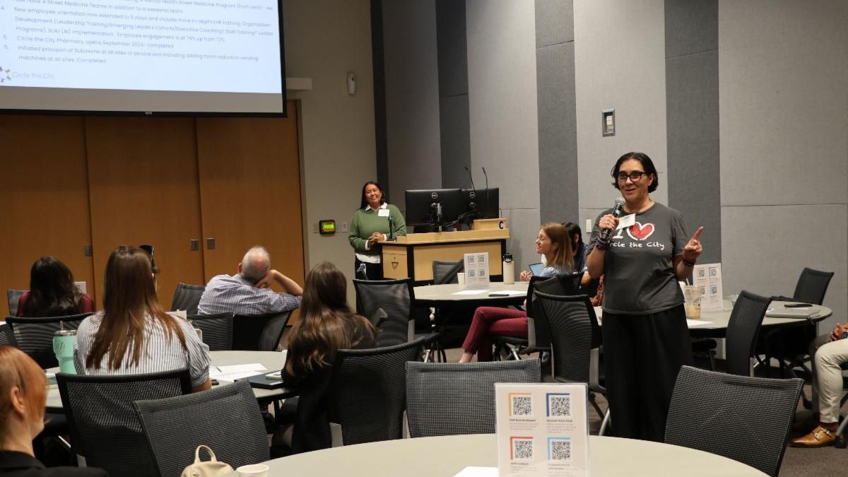 A member of the Synapse Coalition presenting their organization's health priority areas to meeting attendees