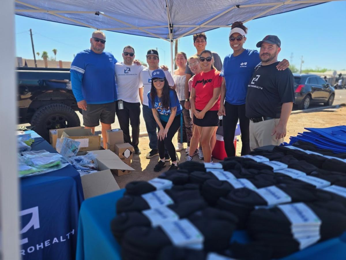 Individuals from Blue Cross Blue Shield of Arizona Health Choice, AZ Langar on Wheels, and Zeihan ProHealth posing for a group photo at an outreach event