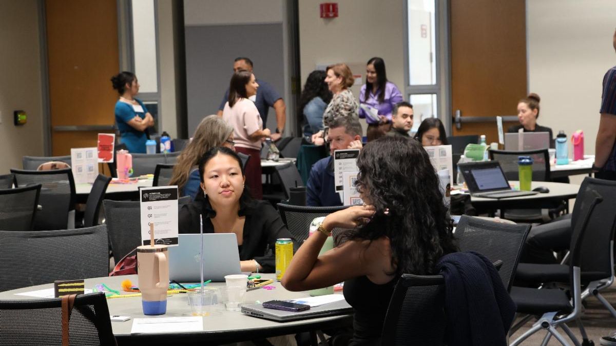 Attendees of the June HIPMC partner meeting socializing with one another during a break