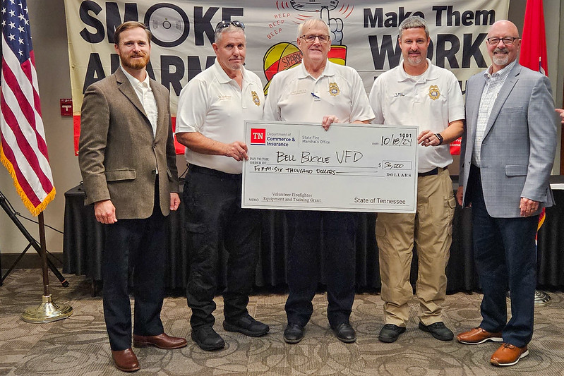 Bell Buckle Volunteer Fire Department officials, flanked by state officials, pose with a replica grant check.