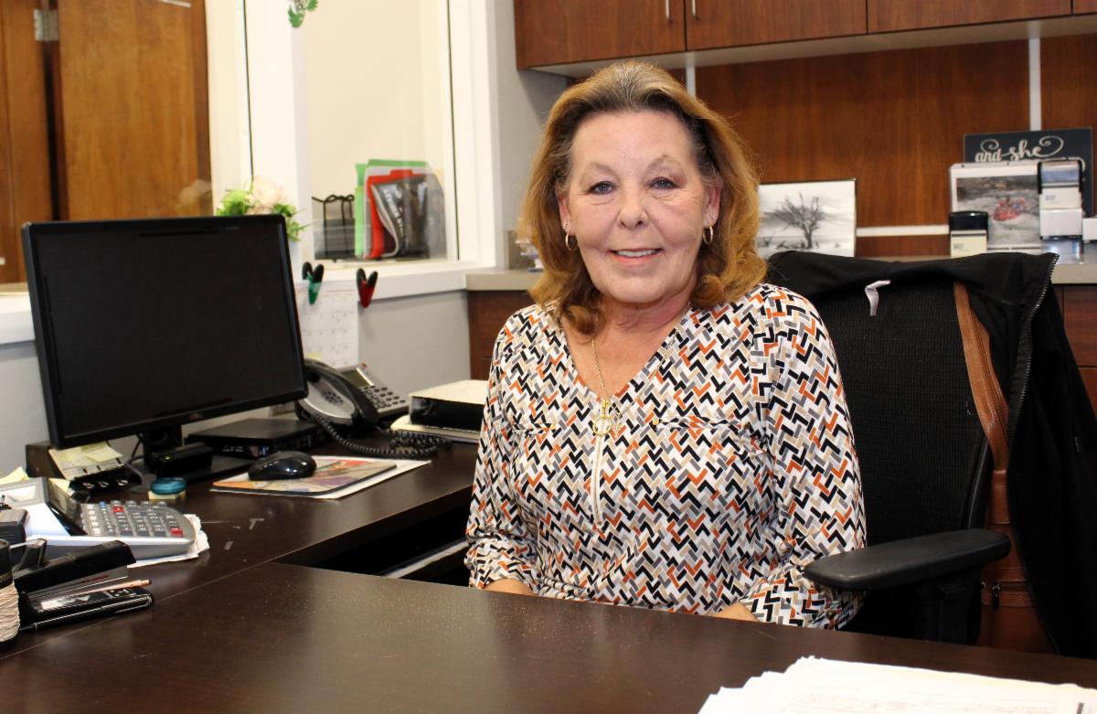 Anne Marie Morton seated at her desk in the Bedford County Clerk's office.