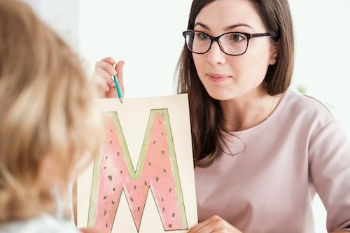 teacher focused on teaching child