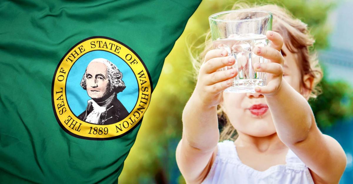 girl holding cup of water and Washington state flag