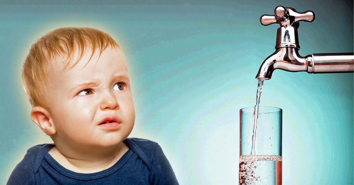 baby looking at faucet