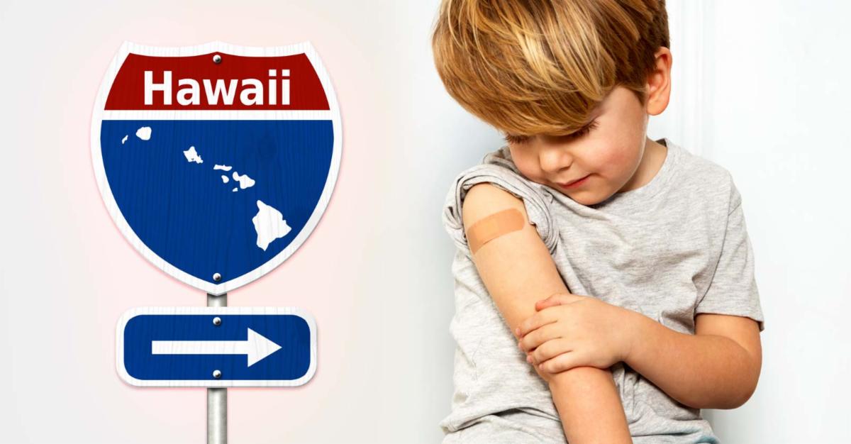 child with vaccine bandage on arm and sign that reads "Hawaii"