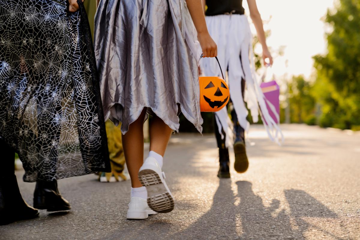 Children trick-or-treating with buckets for candy.