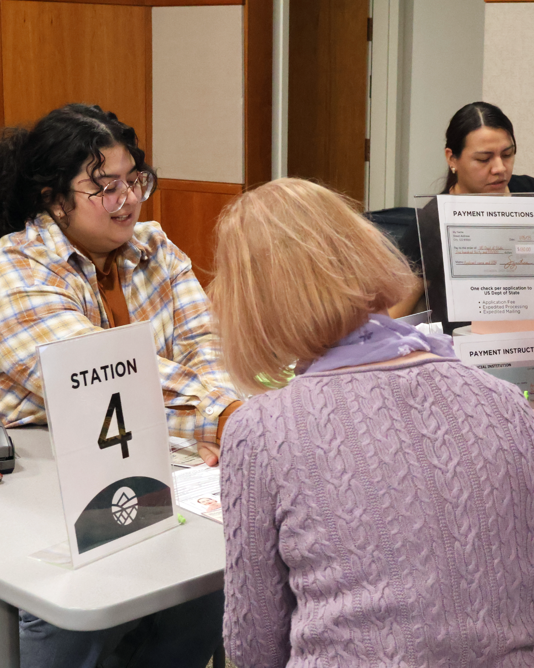 Staff assist a customer with paperwork at a Jefferson County service station.