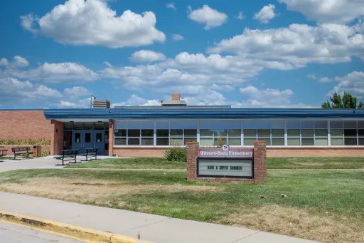 Exterior of Wilmore-Davis Elementary School, showing the main entrance, brick building and front lawn.
