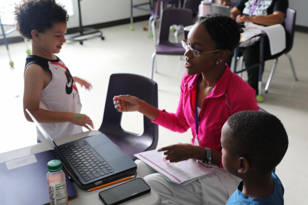 Urban University camper speaking with staff during an activity