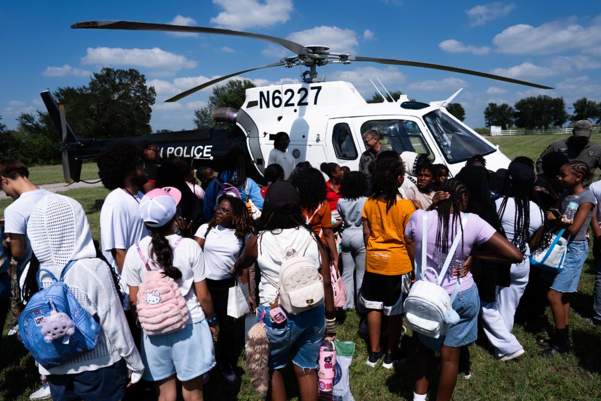 Campers gathering around the helicopter