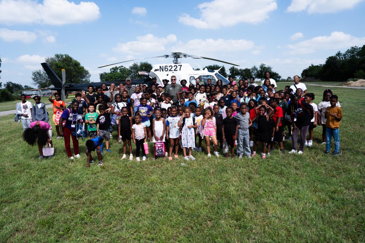 Urban University campers standing with an Austin Police helicopter