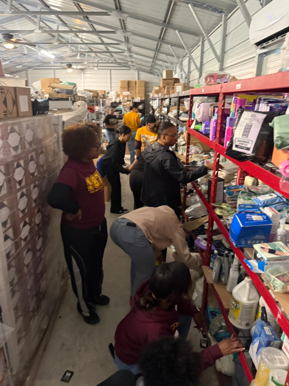 Students organizing AAYHF food and supply storage