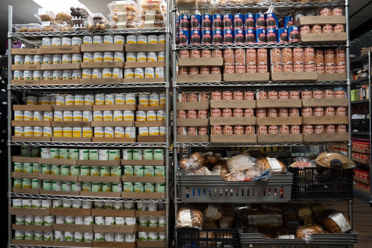 Food pantry shelves filled with canned goods and groceries
