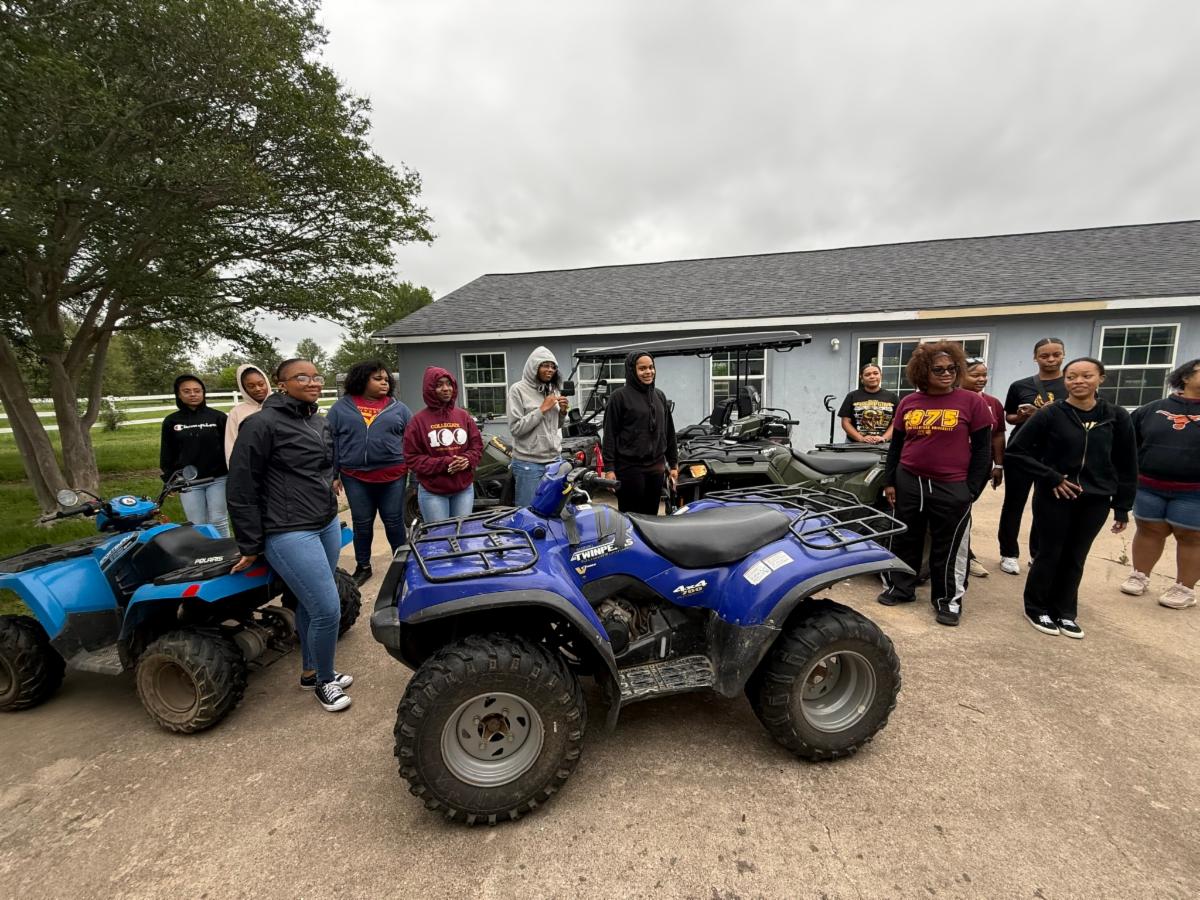 Students visiting AAYHF property with ATVs