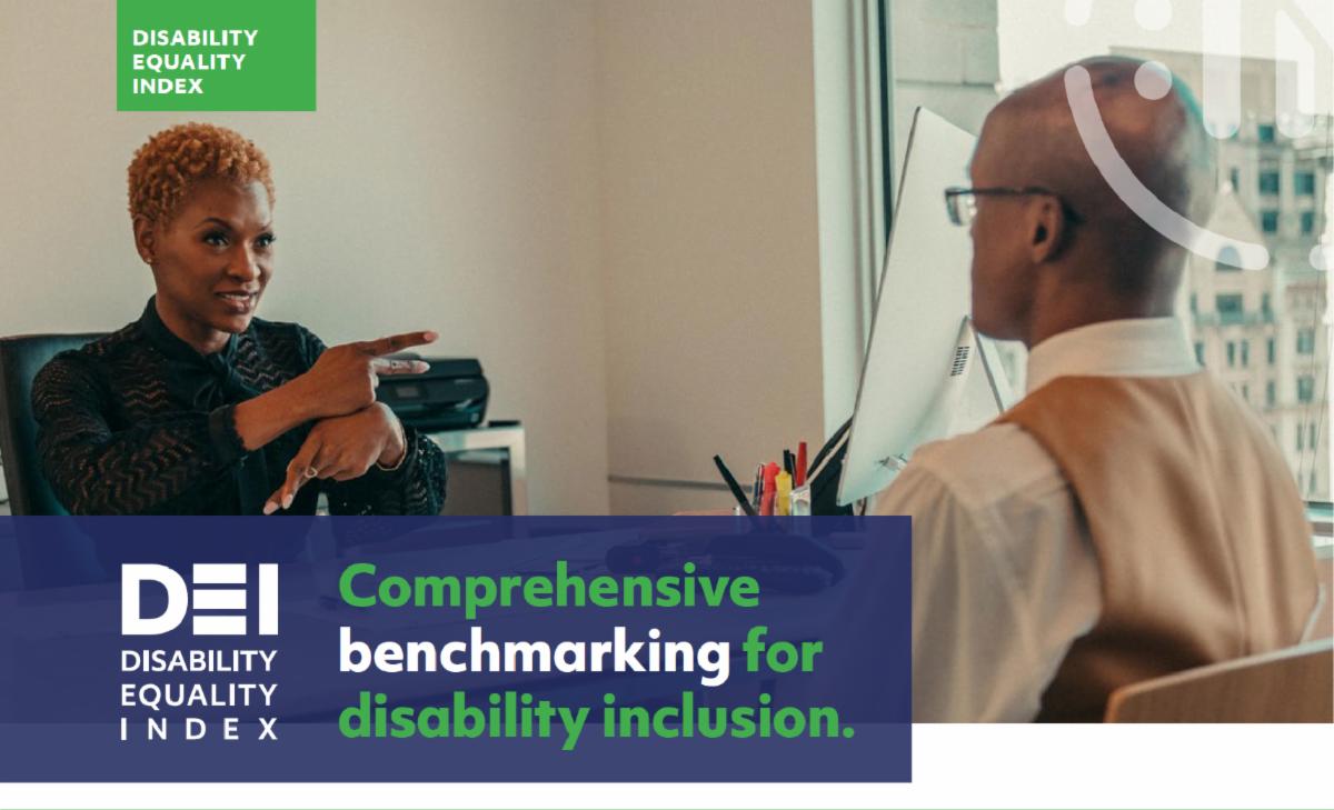 Black woman in office signing to coworker. Disability Equality Index logo. Comprehensive benchmark for disability inclusion.