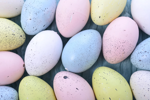 Pastel Easter Eggs on pale blue cheesecloth background. 