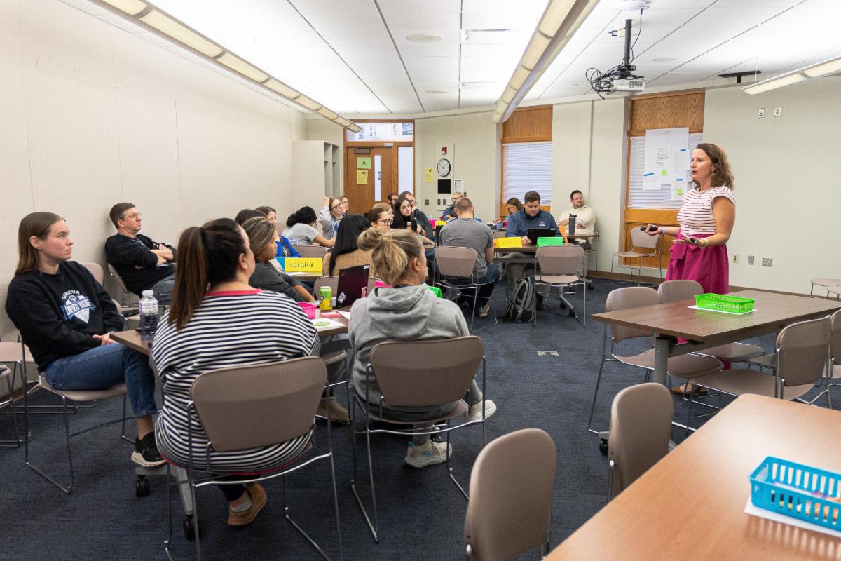 Room of adults in classroom listening to presenter