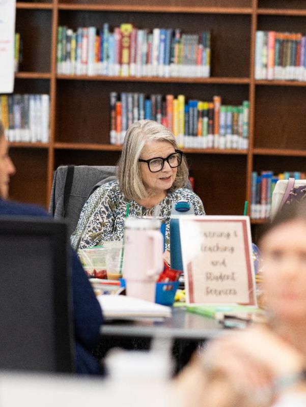 A group of people engaged in a discussion around a table.